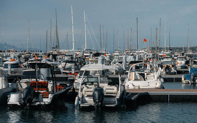 Various boats docked in a busy marina